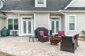 Stamped concrete patio with furnishings in a residential yard in Thornton, Coloradeo